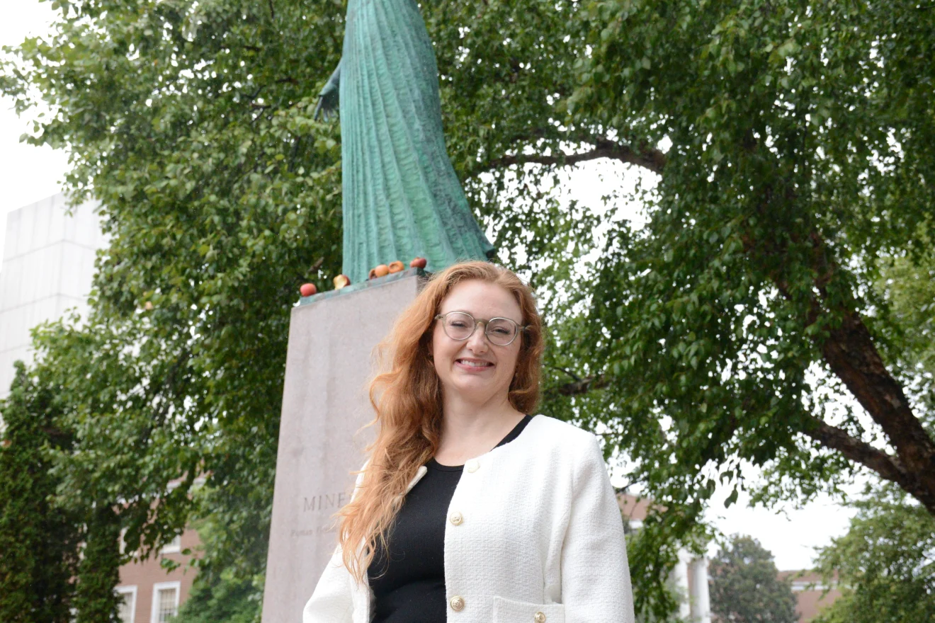 Jessica Marshall smiling in front of UNCG's Minerva statue